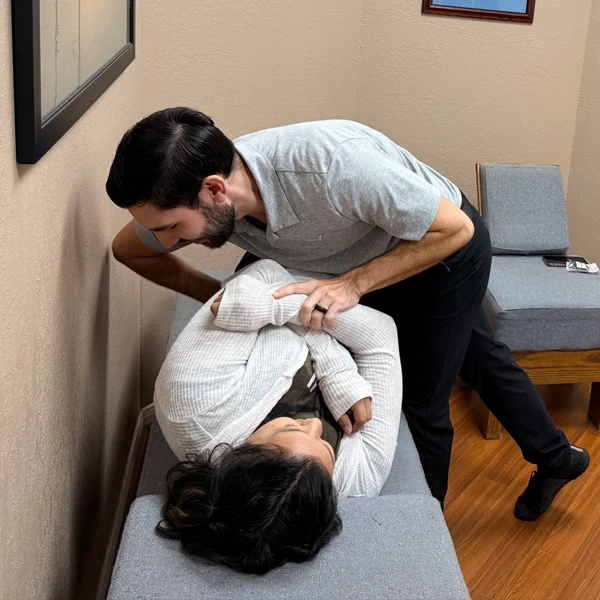 Dr. Justin Bradish adjusting a patient during an appointment